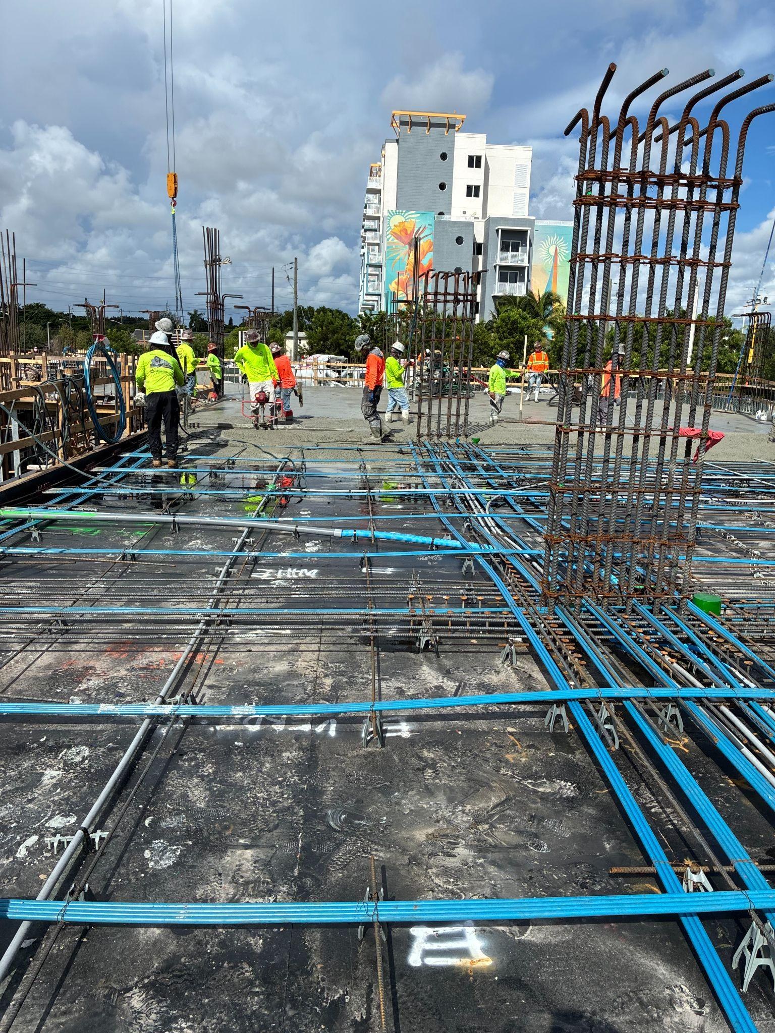 Deck-level rebar and MEP conduit ahead of a slab pour